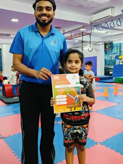 A happy moment as this young gymnast receives her "JUMP" program certificate.