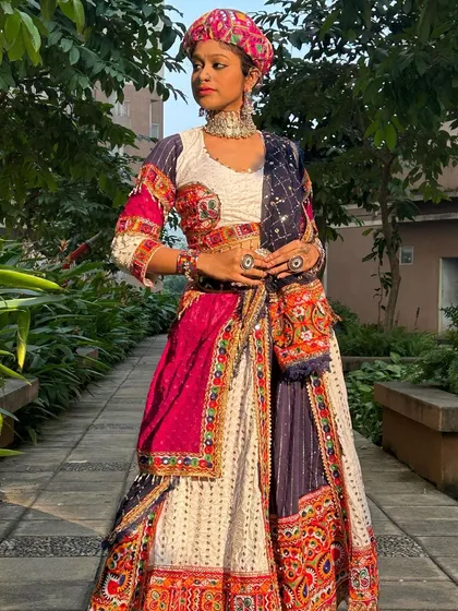 Posing with the pagdi, an essential part of this powerful look. This outfit is perfect for a themed Navratri party or a dance performance.