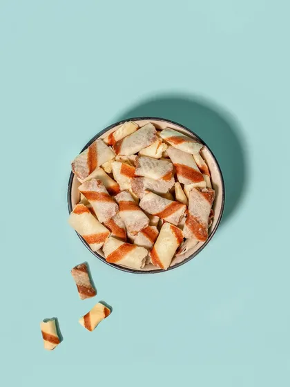 A simple, clean top-down shot of a bowl of snacks against a solid color background. This minimalist style is perfect for e-commerce listings and product catalogues.