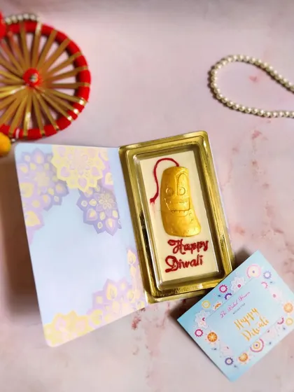 A unique gift for Diwali, this is my chocolate bar book. It opens up to reveal a 'Happy Diwali' themed chocolate bar, making it a sweet and memorable surprise.