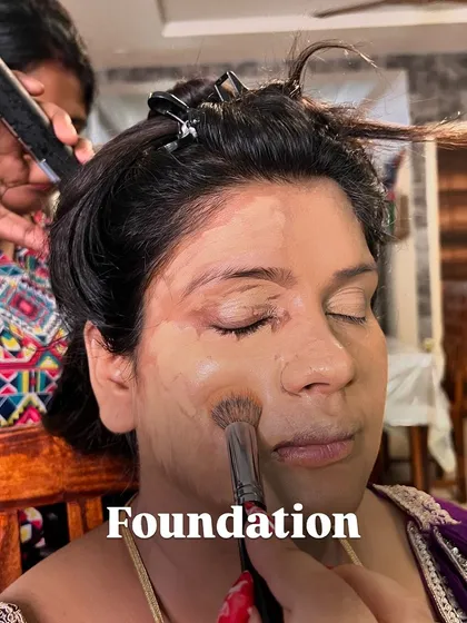 Applying foundation over the corrected and concealed base. The key is to use the right tools and techniques to blend everything seamlessly for a natural skin finish.