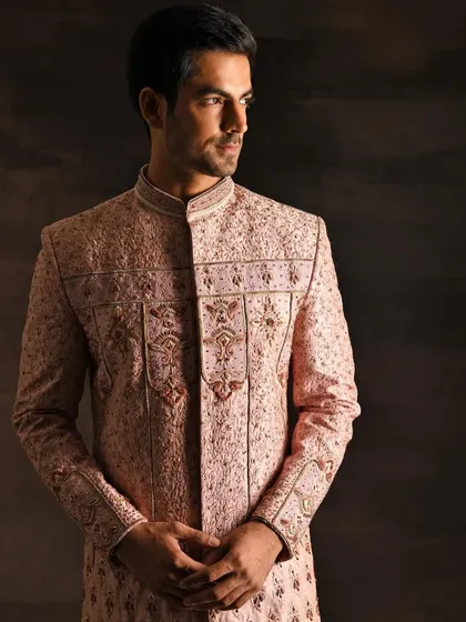 This is a menswear look I styled for a wedding couture campaign. The intricate embroidery on this blush pink sherwani is the hero, showcasing luxury craftsmanship in men's Indian formal wear.