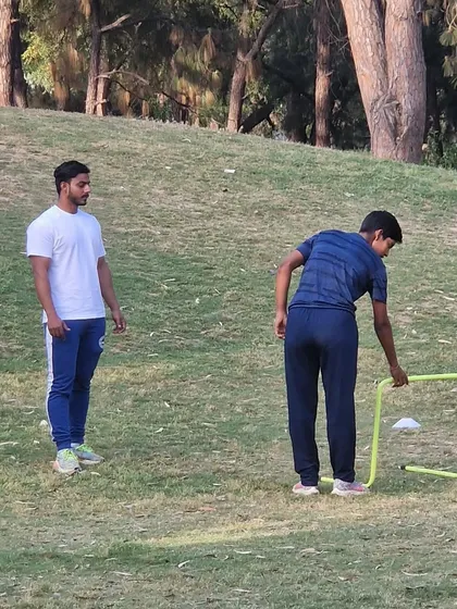 A young athlete setting up equipment for a drill. I encourage my players to take ownership of their training.