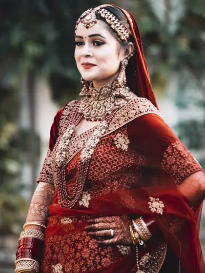 A classic, regal portrait of a North Indian bride. My goal here was to highlight the intricate details of her velvet lehenga, traditional matha patti, and heavy bridal jewelry using soft, natural light.