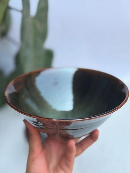 The light catching the glossy interior of our Tenmoku and Chun ramen bowl. The way the glazes melt and flow together in the kiln is pure magic.