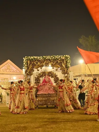 Another perspective of the grand bride entry, showcasing the full entourage of flag bearers and dancers. The coordination and scale are designed to create a jaw-dropping visual impact.