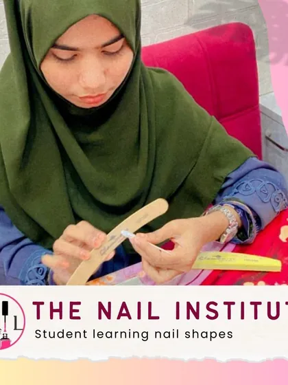 A student gets hands-on practice learning different nail shapes, a fundamental skill for any nail technician.