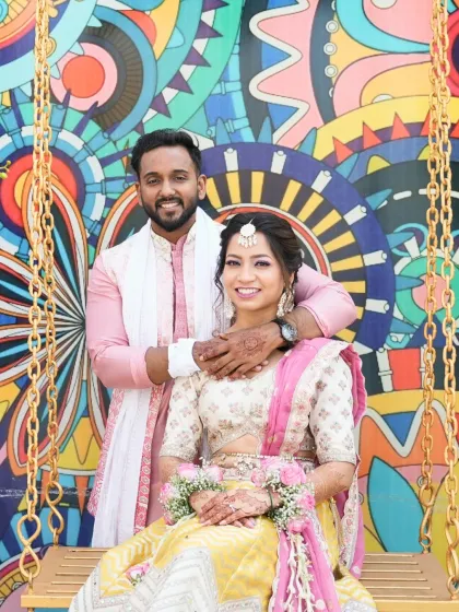 Another happy portrait of the couple. The bride's makeup is radiant and joyful, a perfect match for the colorful backdrop.