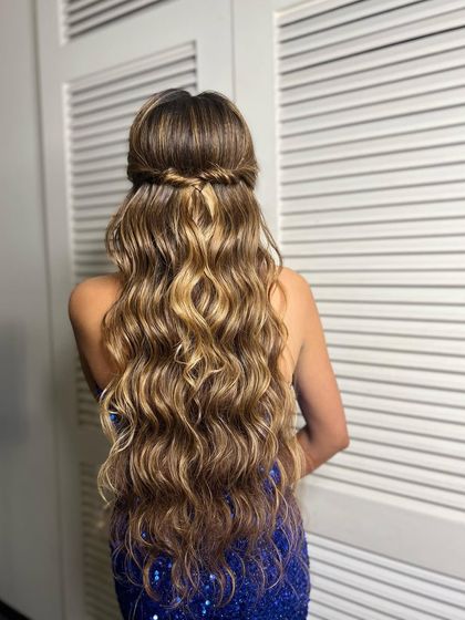 The back view of the cocktail hairstyle, featuring a simple twist and a cascade of beautiful waves.