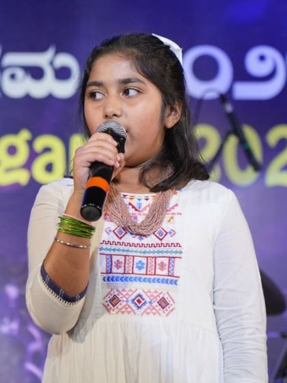 Student Kyra Puri sings with passion during her duet performance at our annual show. We train students to perform with confidence and expression.