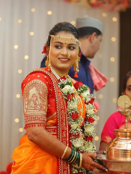 A portrait of the bride during the wedding rituals. The intricate embroidery on her blouse and the traditional jewelry are key elements of her stunning look.