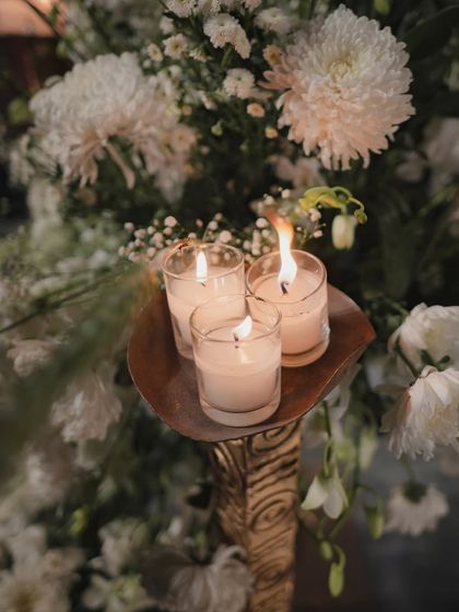 A detail of the elegant, all-white floral decor. We used candles and soft lighting to create a warm, romantic glow amidst the pristine white blooms for this Jodhpur wedding.