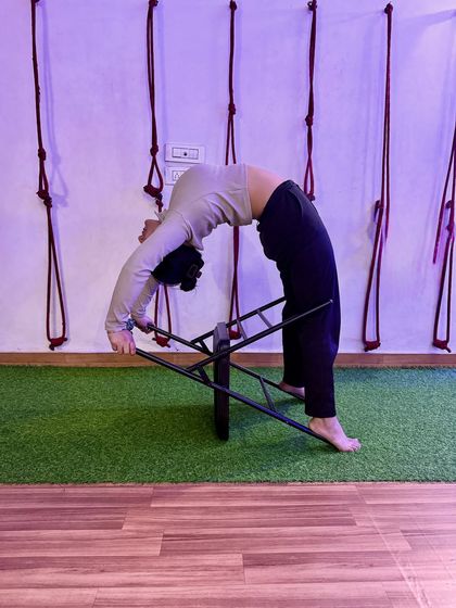Feeling the full stretch in my spine with the help of the chair. Props are amazing tools for exploration.