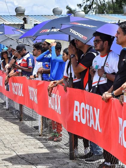 Spectators line the fence, showing the strong support and engagement from the karting community at our events.