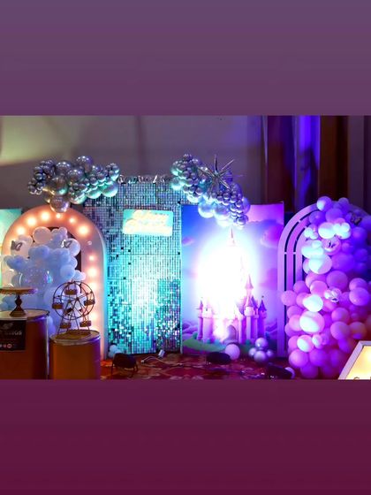 A low-light view of the elaborate princess party stage, showing how the lighting creates a magical, ethereal glow.