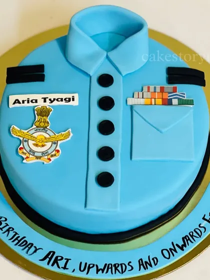 A retirement cake designed as an Air Force officer's uniform. This fondant cake is detailed with the official insignia, medals, and name tag for a truly personal tribute.