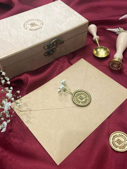 The complete personalised wax seal stamp set, including the engraved wooden box and the custom stamp.