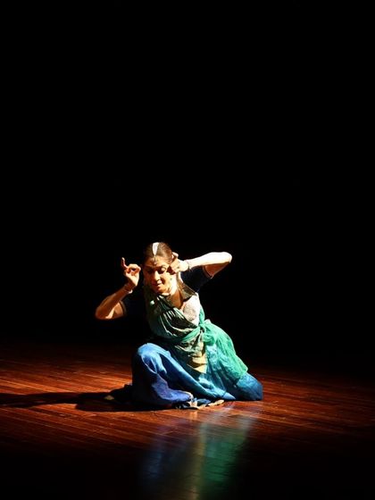 A dancer in a moment of quiet contemplation during "Immersed."