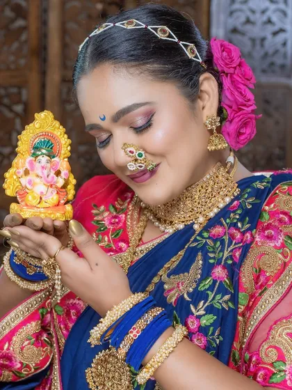A close-up showcasing the intricate nath and the soft, glowing makeup against the festive backdrop.