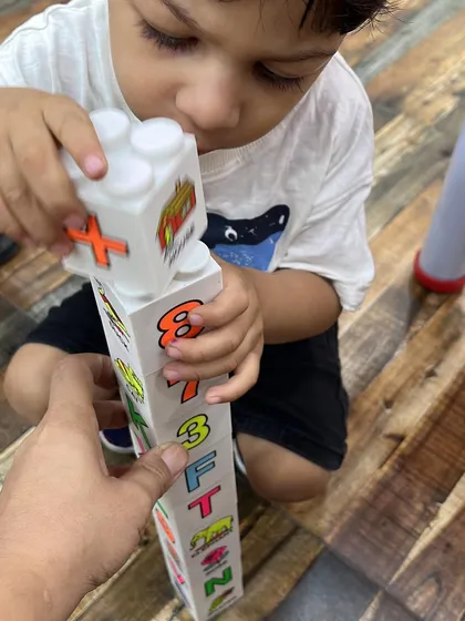 Building towers with number blocks is another fun way we practice number recognition and counting in our mother-toddler program.