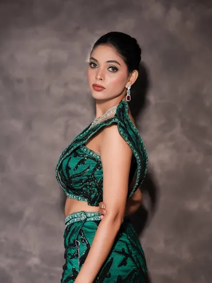 A three-quarter view of the model, showing the full effect of the outfit, hair, and makeup.