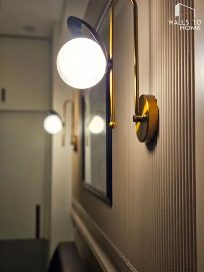 A sneak peek of a master bedroom design, focusing on an elegant wall sconce. The image teases a sophisticated and cozy space that is coming soon.