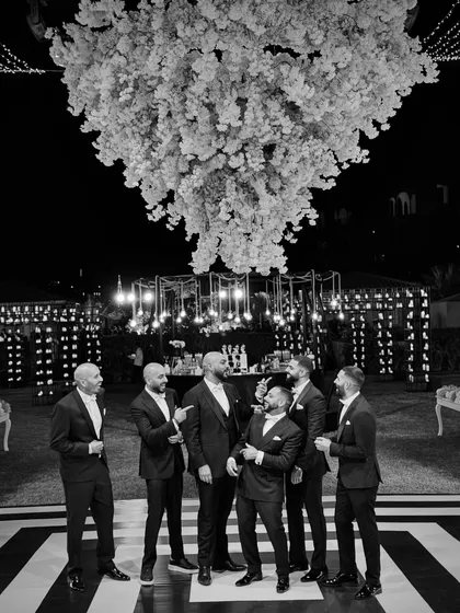 The Kudos Music team on the custom black and white dance floor at the Bahrain wedding. We're a brotherhood, and we celebrate together.