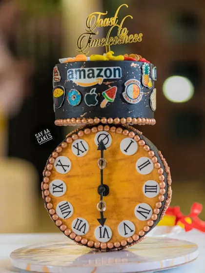 A client requested an anti-gravity cake for a 60th birthday with an antique clock as the showstopper. This was the result, a gravity-defying design where the clock face balances perfectly, surrounded by edible models of the husband's favorite brands and foods.