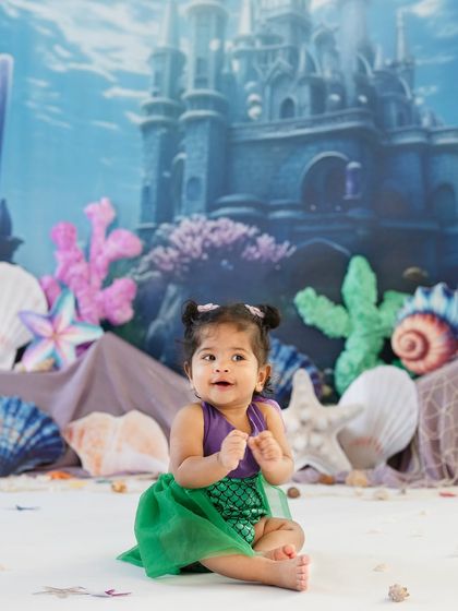 Our little mermaid is exploring her underwater kingdom. The colorful coral and seashell props create a magical ocean scene for this sitter session.