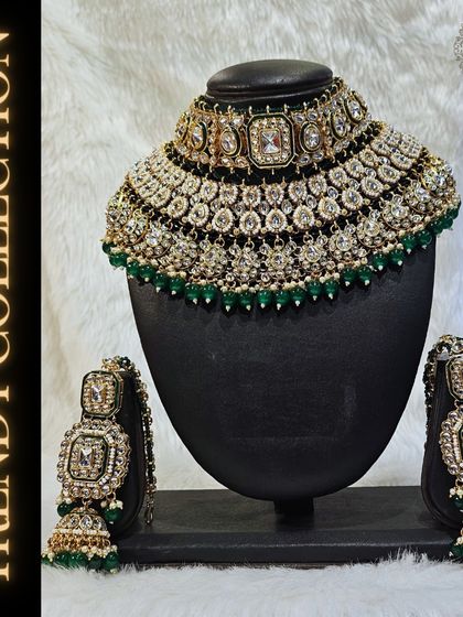 Part of our trendy collection, this heavy Kundan bridal set with green beadwork is a showstopper. It includes a choker, matching jhumkas, and intricate detailing for a complete look.