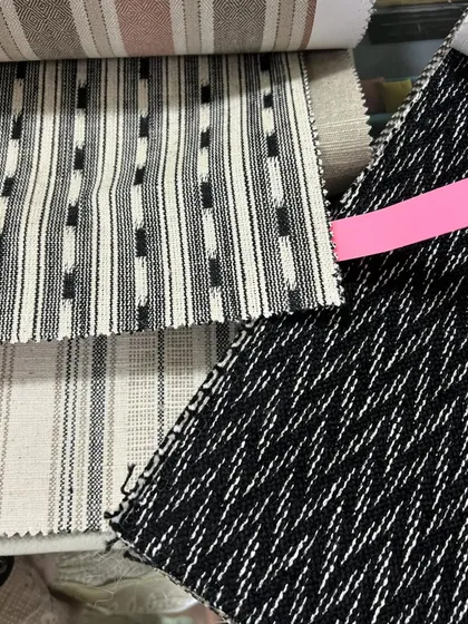 Selecting the right fabric is just as important as selecting the right wood. These are some of the textile swatches for a project, showing a mix of patterns and weaves that will be used for upholstery.