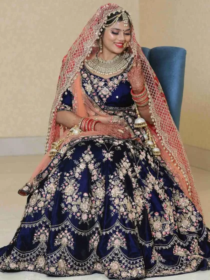 This is a navy blue velvet bridal lehenga with full french knot and zari handwork. It’s a perfect example of the detailed craftsmanship I offer, and it's available for you to either buy or rent.