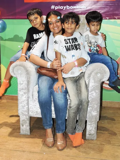 A mother and her sons pose on a special throne-like chair during our Mother's Day event.