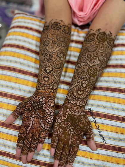 This detailed design was for an engagement bride. It features delicate hearts and intricate netting, covering the hands and arms completely for a traditional look.