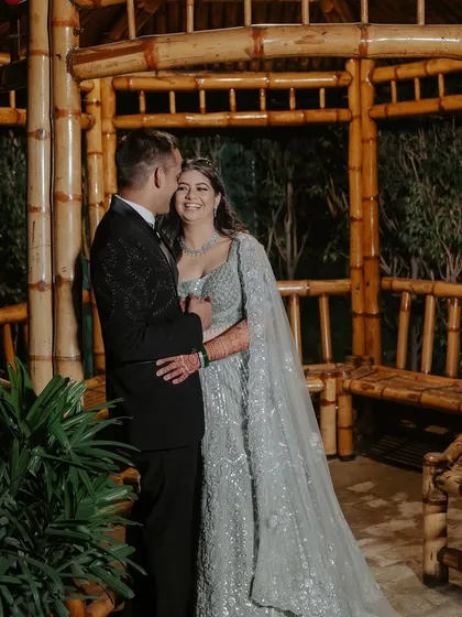 A romantic shot of the couple. Her makeup is soft and elegant, perfect for an evening engagement party.