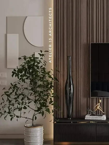 A minimalist detail showing a fluted wood media console, a simple potted plant, and geometric wall art. This composition demonstrates our ability to create sophisticated spaces with clean lines and carefully chosen objects.