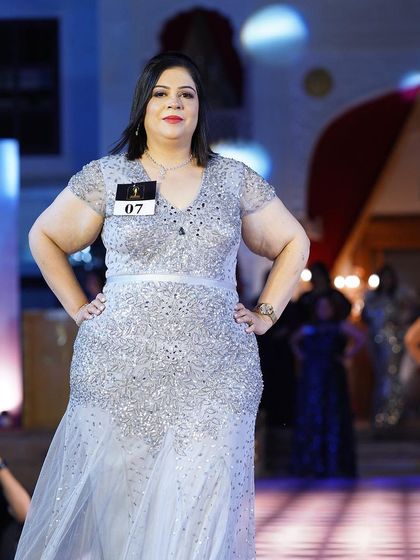 Another shot of the silver sequined plus-size gown, highlighting its flattering A-line shape.