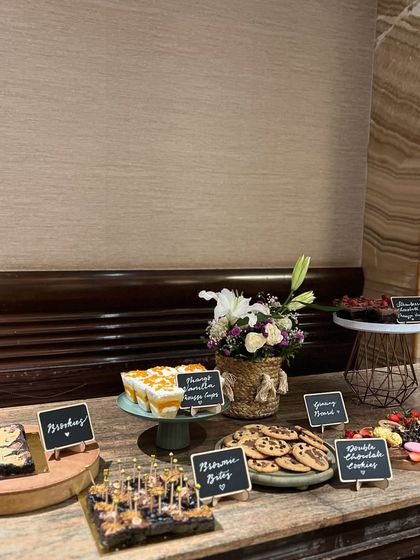 A wider shot of the dessert table, showing the full spread of our bite-sized, eggless treats. We can create a beautiful and delicious setup for any party.