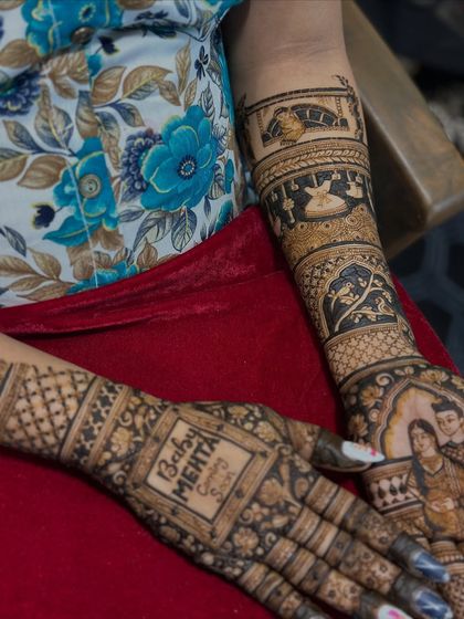 A detailed shot of the "Baby Mehta Coming Soon" announcement, framed by beautiful floral patterns.