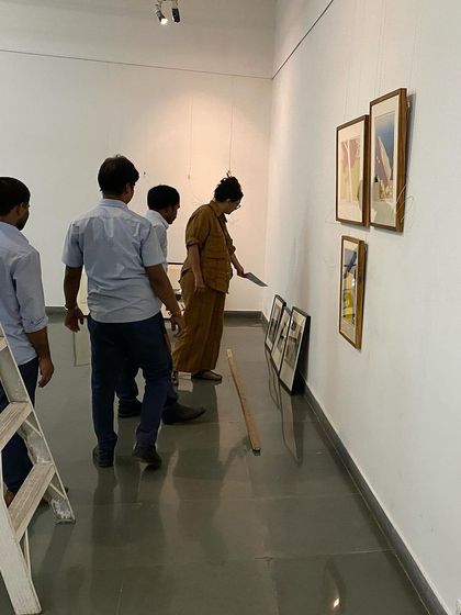 The team working on the lighting and final placement of artworks.