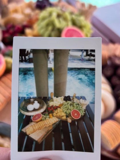 A creative polaroid shot of a poolside grazing platter. This image captures the fun and relaxed vibe of the event while highlighting the beautiful food display.