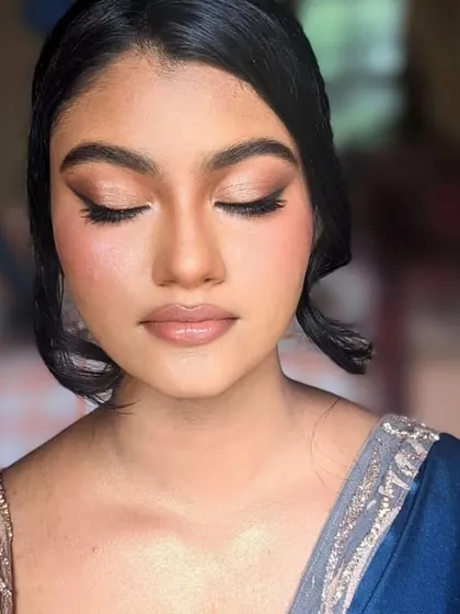 A perfect example of a soft, natural look that shines bright. The makeup is minimal, with a focus on glowing skin, a simple winged liner, and a nude lip.