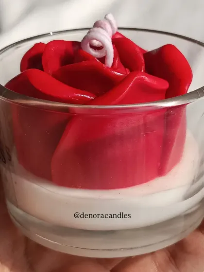 A side view of the red rose jar candle.