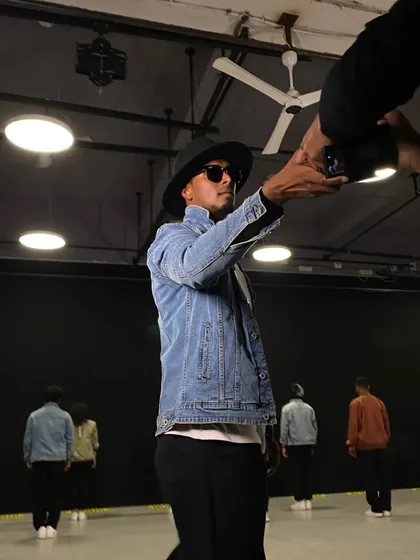 Behind the scenes of a video shoot. As a director, I'm involved in every aspect, from the choreography to the visual storytelling.
