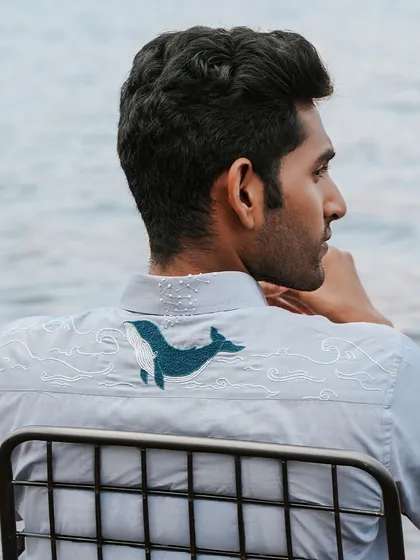 Our 'Soaring Whale' shirt showcases the magic of hand-embroidery. It takes over 16 hours of artistry to create this design, a process impossible for a machine to replicate. It’s for the man who appreciates craftsmanship and carries a story in his style.