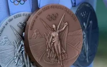 A close up of the coveted Olympic medals. These represent the pinnacle of sporting achievement that we relentlessly work towards at the academy.