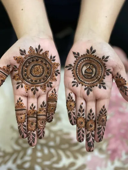 I love personalizing mandalas. This set features a rose in one and a small dome in the other, surrounded by sun-like rays and detailed finger designs.