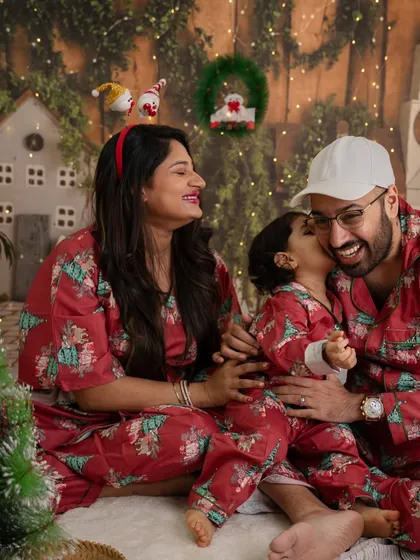 A candid moment of love and laughter from a previous year's Christmas mini session, with the family dressed in matching pajamas.