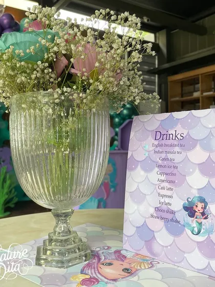 For a 'Mermaid' party, I designed custom menus and placemats with iridescent colors and mermaid graphics.