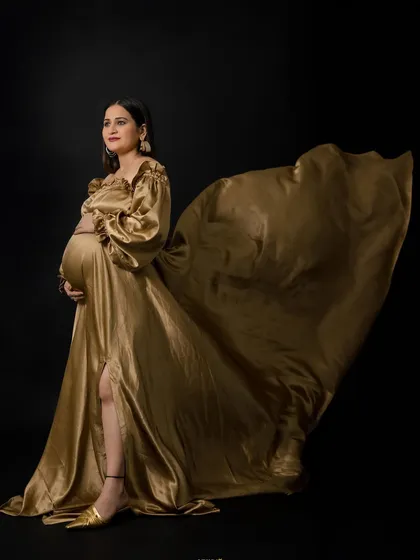 Go for gold with our glamorous Taylor gown. This two-piece satin ensemble features dramatic balloon sleeves and a flowing skirt with a slit, creating a show-stopping goddess look that's sure to turn heads.